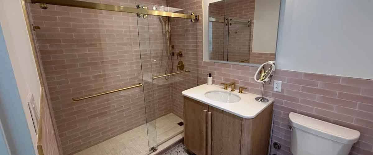 Custom frameless glass shower door installation in modern NYC bathroom by Levinson Glass