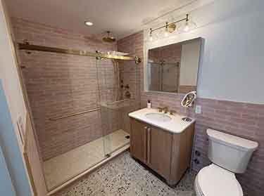 Frameless glass shower door professionally installed in a modern NYC bathroom