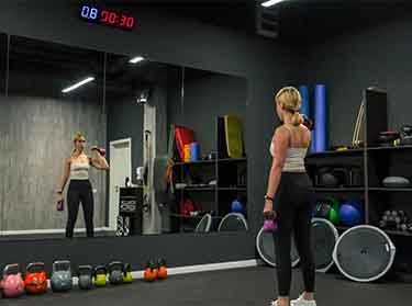 Full-length mirror installation in NYC gym for enhanced visibility and space perception