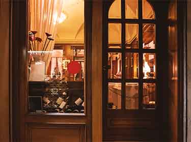 Window replacement with custom glass at a wine shop in New York City for improved visibility and insulation